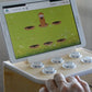 BrainTagger button box with a tablet showing a whack-a-mole game.